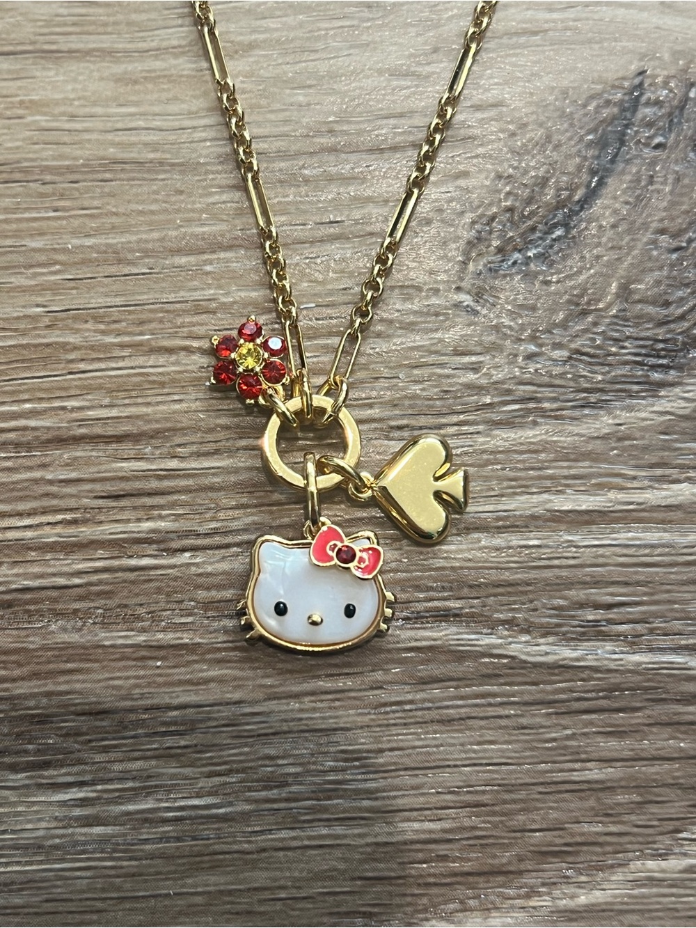 Kate Spade Hello Kitty Gold Tone Necklace with White Enamel Face and Red Bow